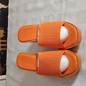Women's orange sandal, stretchy band across.